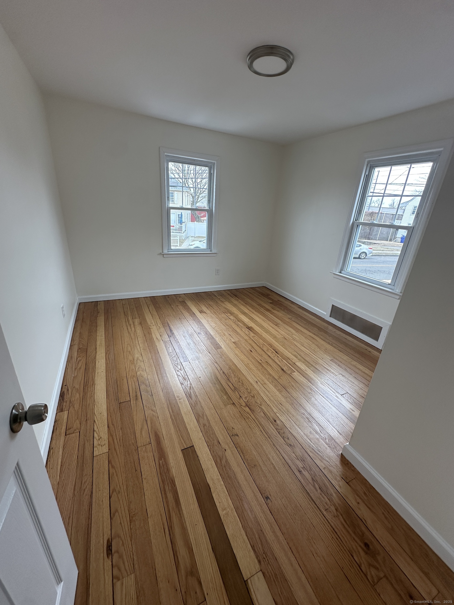 11 Colony Street Stratford, CT 06615 - Photo 16 of 16 wooden floor in an empty room with a window