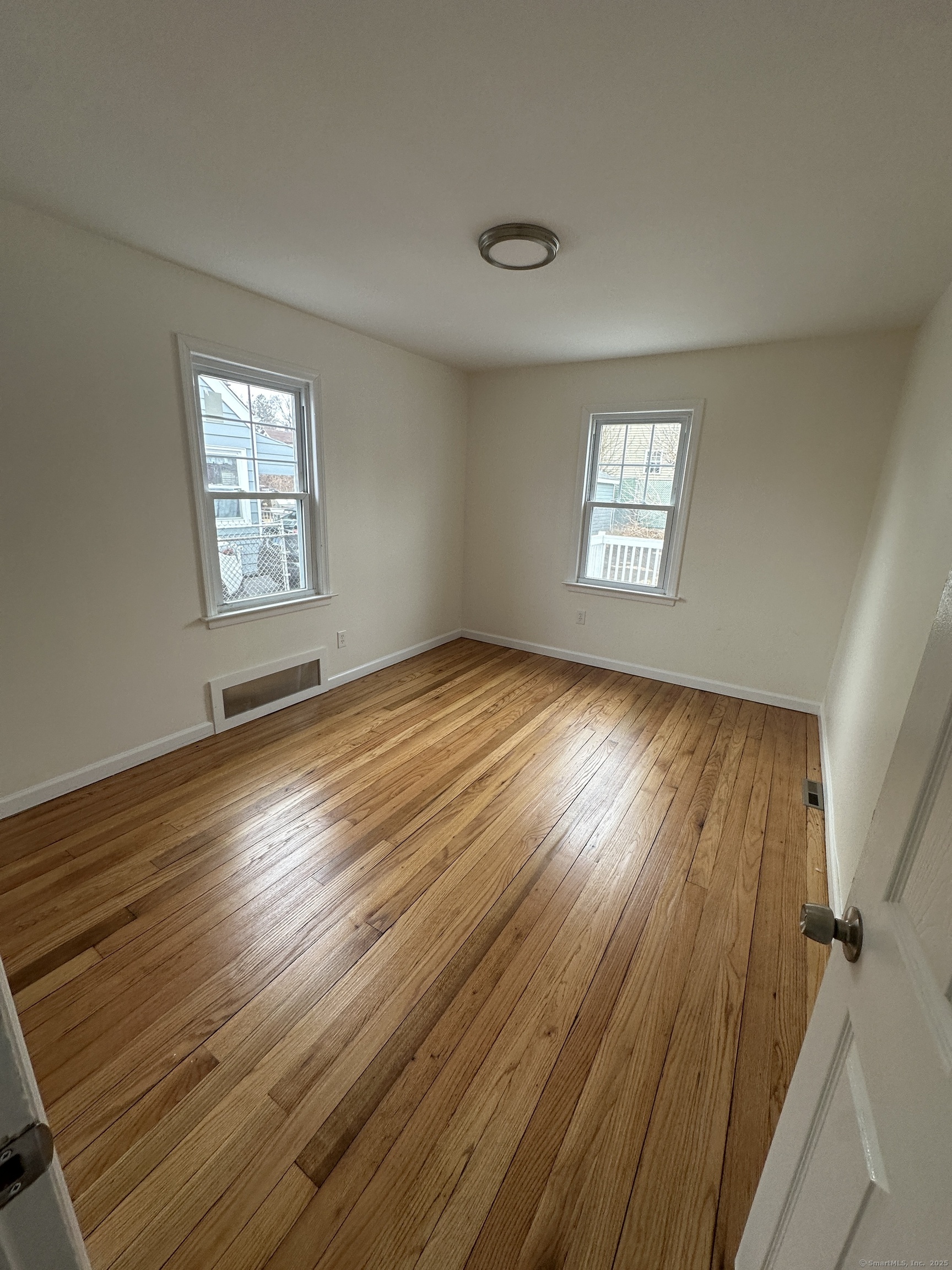 11 Colony Street Stratford, CT 06615 - Photo 10 of 16 wooden floor in an empty room with a window