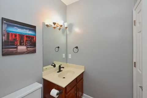 a kitchen with stainless steel appliances granite countertop a stove a sink a refrigerator a dining table and chairs with wooden floor