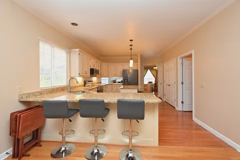 a large kitchen with a table and chairs