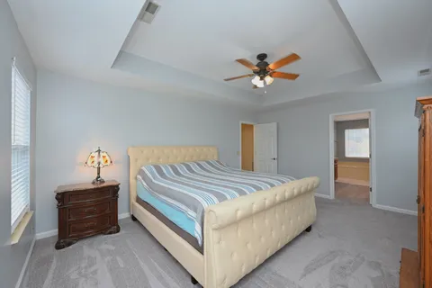 a spacious bathroom with a tub sink and mirror