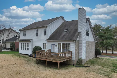 a view of a house with a backyard and a patio