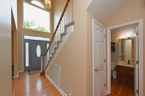 a view of a hallway with wooden floor and windows