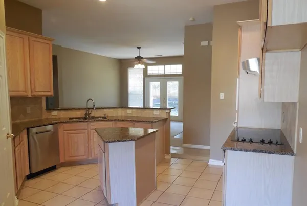 a kitchen with stainless steel appliances granite countertop a sink and a stove