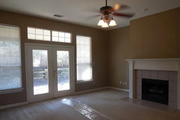 a view of a livingroom with a fireplace and window
