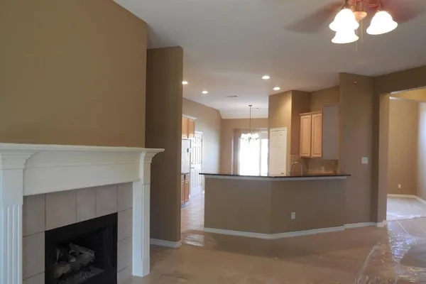 a view of an empty room with window and fireplace