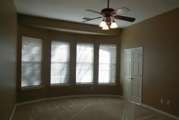 a living room with windows and chandelier