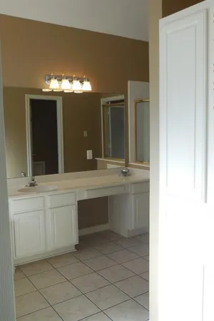 a bathroom with a double vanity sink and a mirror