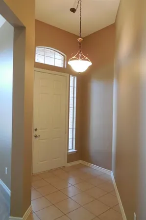 a view of a chandelier fan and entryway