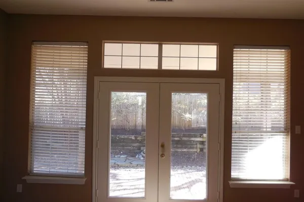 a view of a yard with wooden fence