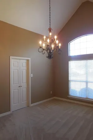 a view of a chandelier in a room and a window