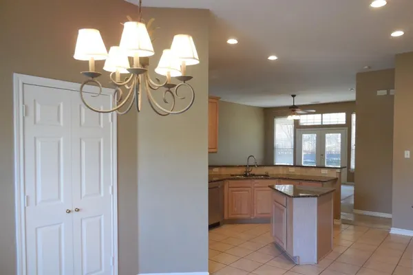 a view of a kitchen with granite countertop a sink and a stove
