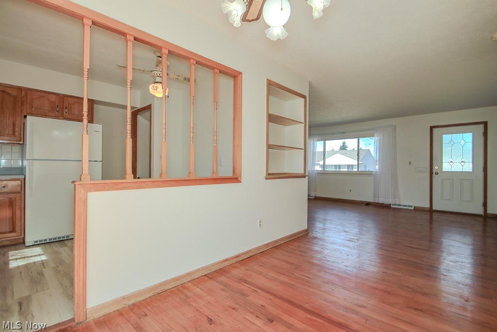 30224 Regent Road Wickliffe, OH 44092 - Photo 3 of 27 Unfurnished living room with light wood finished floors and suspended lighting