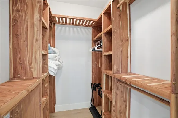 a room with a bed and a night stand
