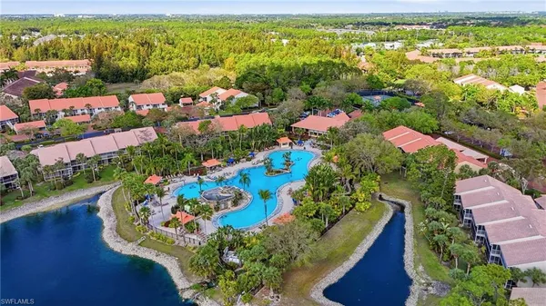 an aerial view of a house with a yard and outdoor seating