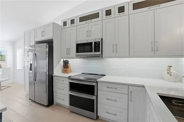a kitchen with stainless steel appliances kitchen island granite countertop a sink and cabinets