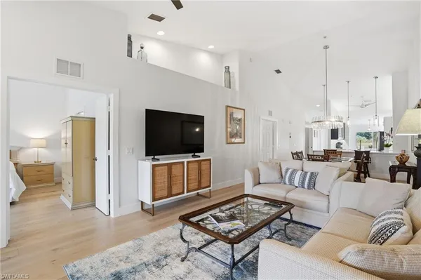 a kitchen with stainless steel appliances white cabinets and a refrigerator