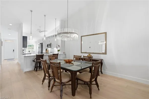 a living room with furniture a flat screen tv and kitchen view