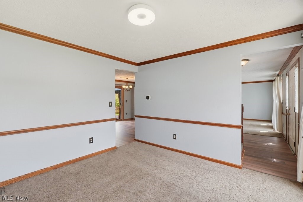 5321 Young Road Stow, OH 44224 - Photo 21 of 37 Carpeted room with light grey walls and wood molding
