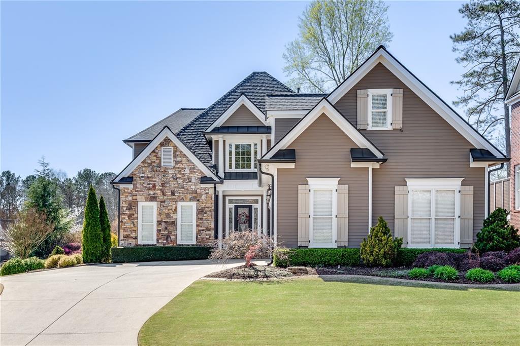 a front view of a house with garden