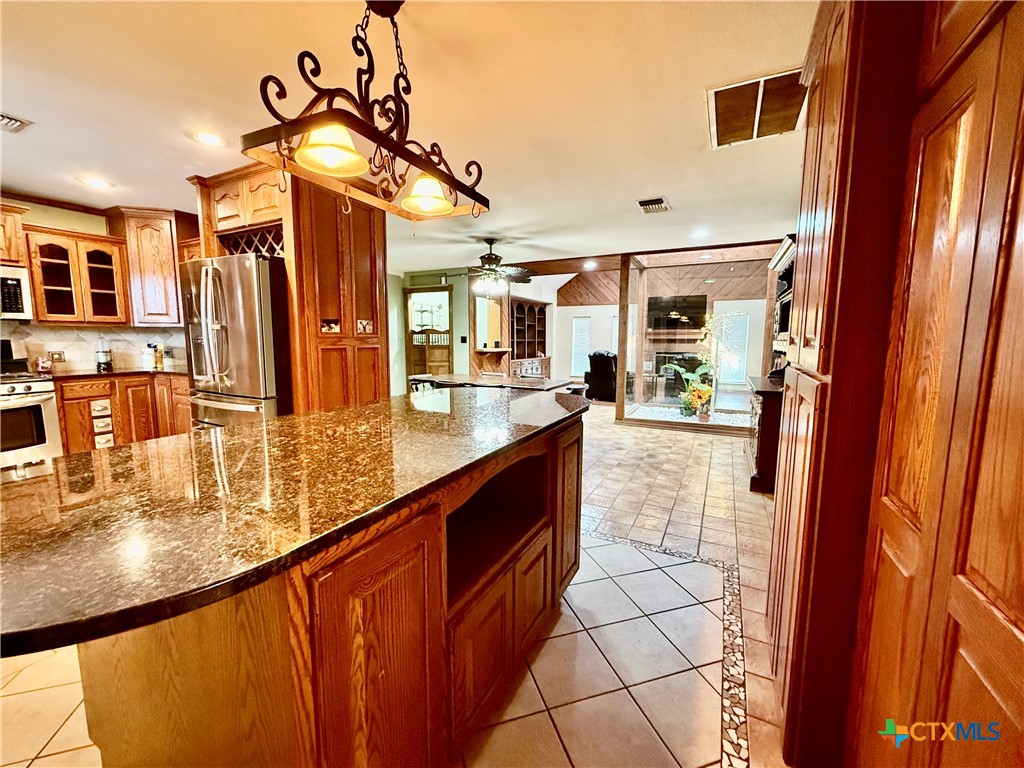 20 Hambleton Road Victoria, TX 77905 - Photo 12 of 42 a large kitchen with stainless steel appliances granite countertop a sink and cabinets