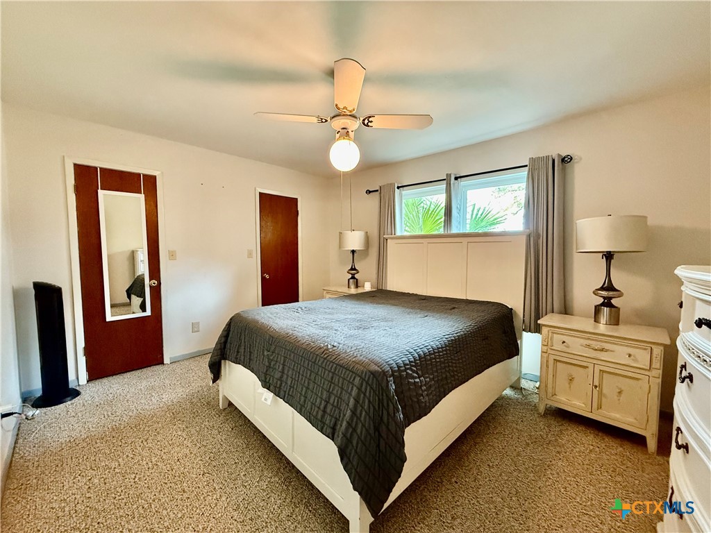 20 Hambleton Road Victoria, TX 77905 - Photo 23 of 42 a spacious bedroom with a bed and a chandelier