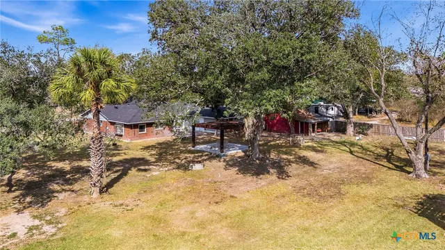 a view of a house with a yard and garage