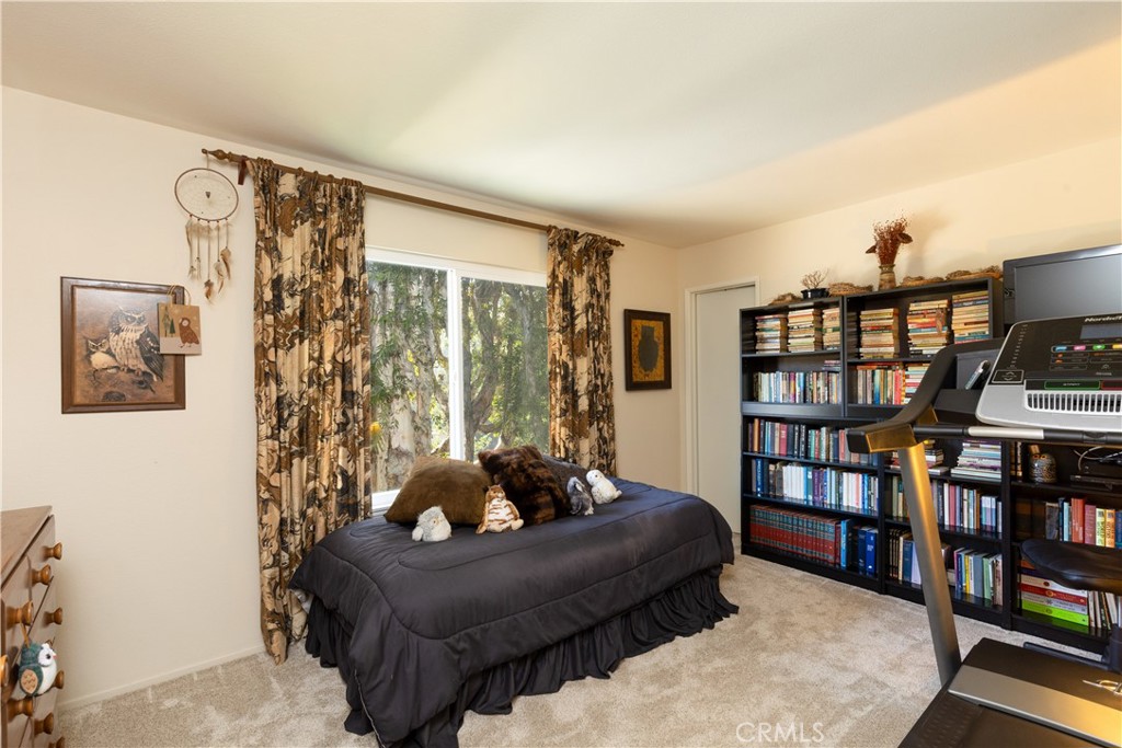 8224 Seranata Drive Whittier, CA 90605 - Photo 16 of 55 a living room with furniture and a book shelf