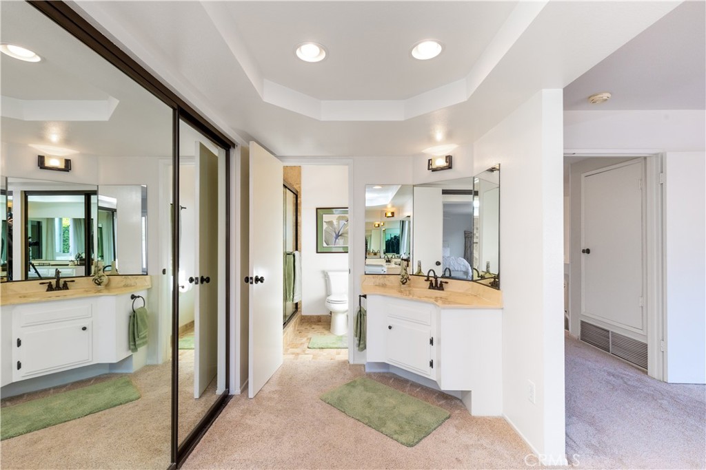 8224 Seranata Drive Whittier, CA 90605 - Photo 23 of 55 a bathroom with a tub sink vanity granite and a view of living room