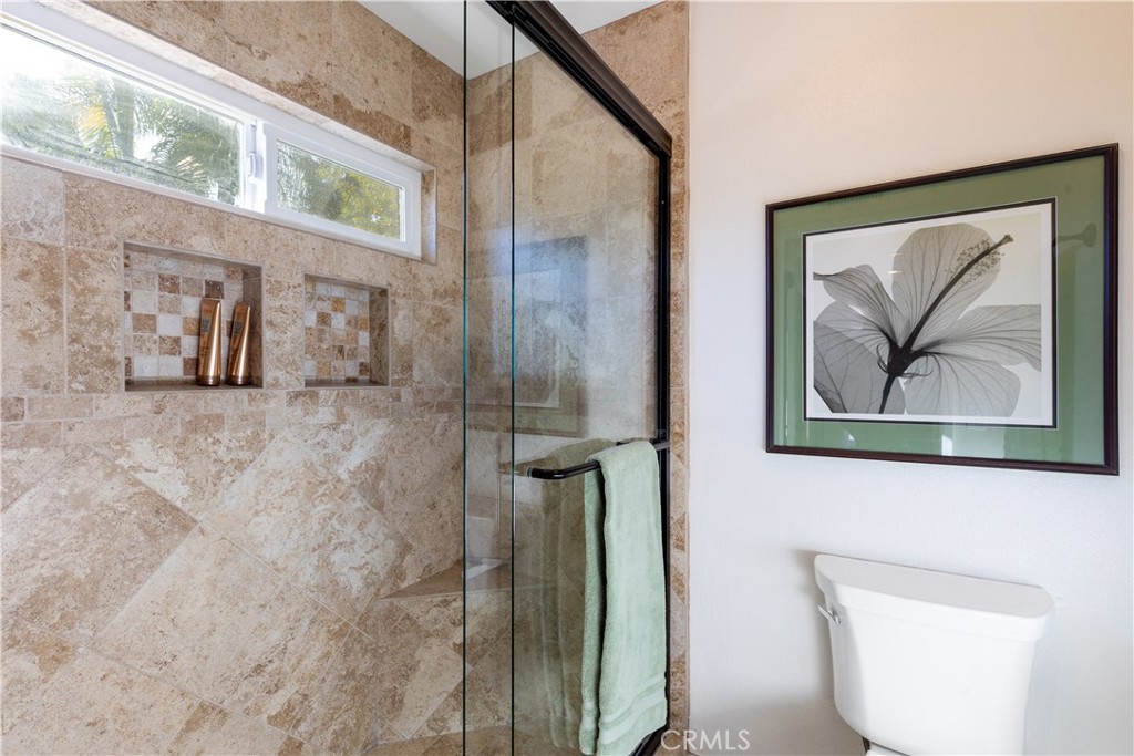 8224 Seranata Drive Whittier, CA 90605 - Photo 24 of 55 a bathroom with a shower and a painting on the wall