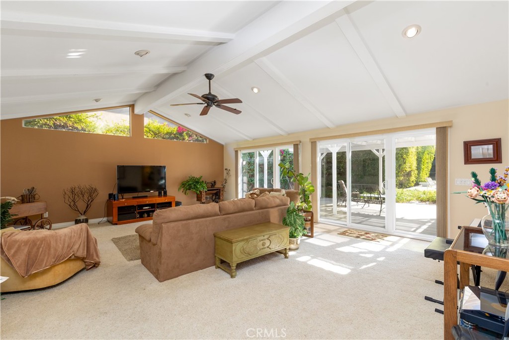 8224 Seranata Drive Whittier, CA 90605 - Photo 35 of 55 a living room with furniture a flat screen tv and a large window