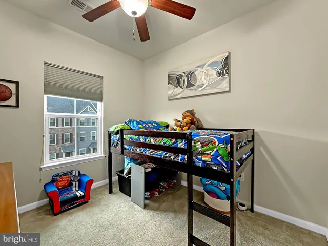 a bedroom with furniture a baby crib and a wooden floor