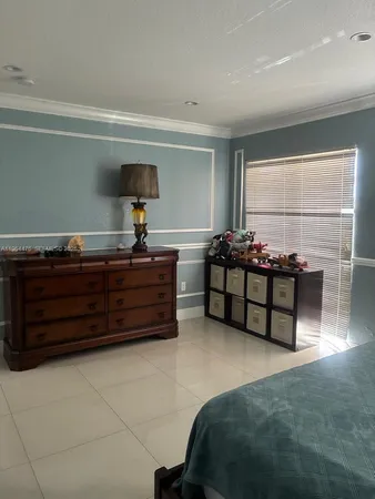 a bedroom with furniture and window
