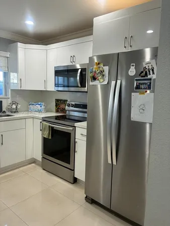 a kitchen with stainless steel appliances a refrigerator stove and microwave