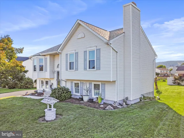 a front view of a house with a yard fire pit and outdoor seating