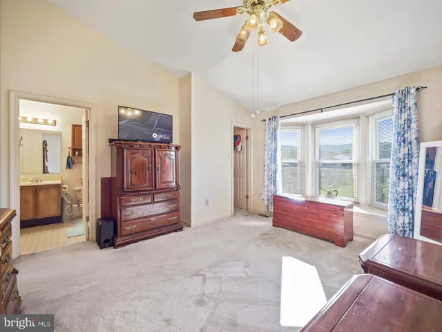 a spacious bedroom with a bed and a chandelier