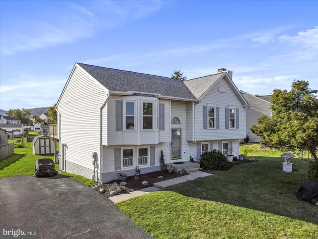a front view of a house with a garden and patio