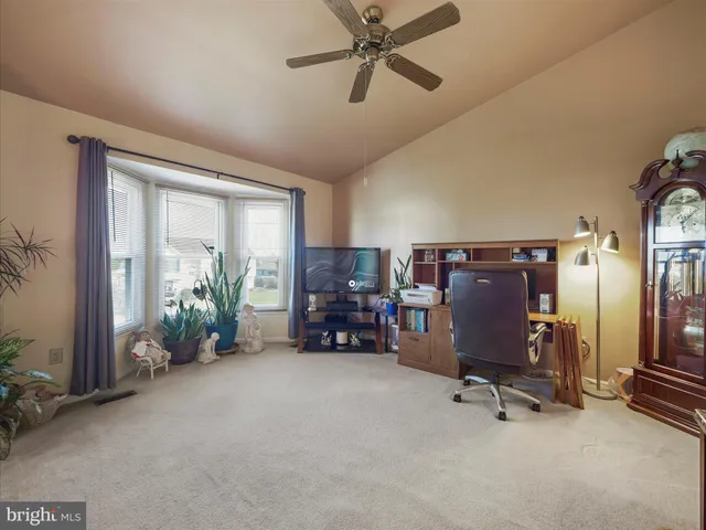 a view of a livingroom with furniture and a gym cycle