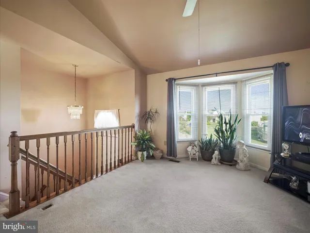 a view of a livingroom with furniture and floor to ceiling window
