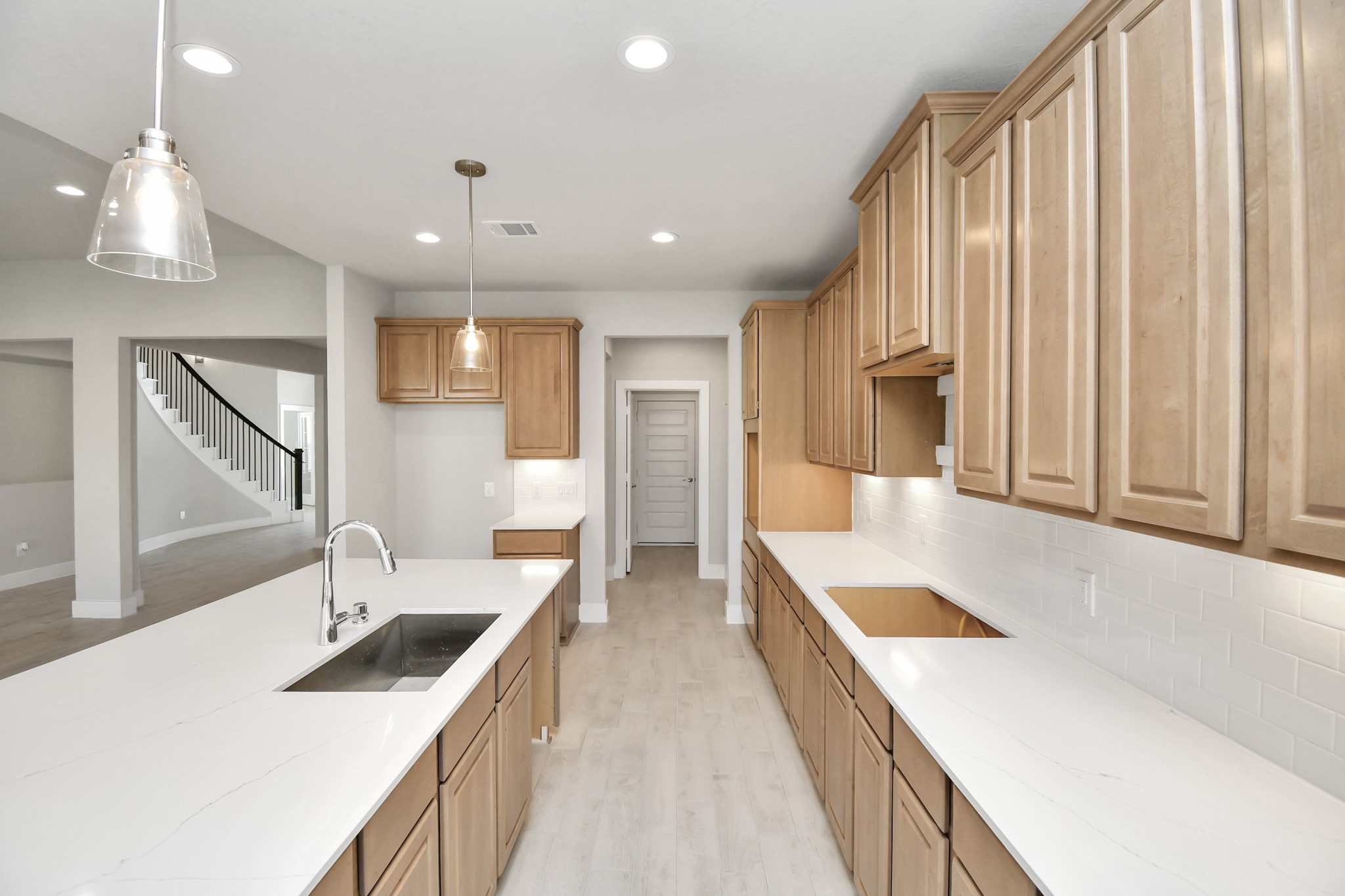 3106 Native Spg Drive Spring, TX 77373 - Photo 11 of 38 This kitchen is by far any chef’s dream! This spacious kitchen features high ceilings, light stained wood cabinets, granite countertop, SS appliances, modern tile backsplash, recessed lighting, extended counter space, granite kitchen island with double sink, and space for breakfast bar, and a walk-in pantry all overlooking your huge family room. Sample photo of completed home with similar floor plan. Actual colors and selections may vary.