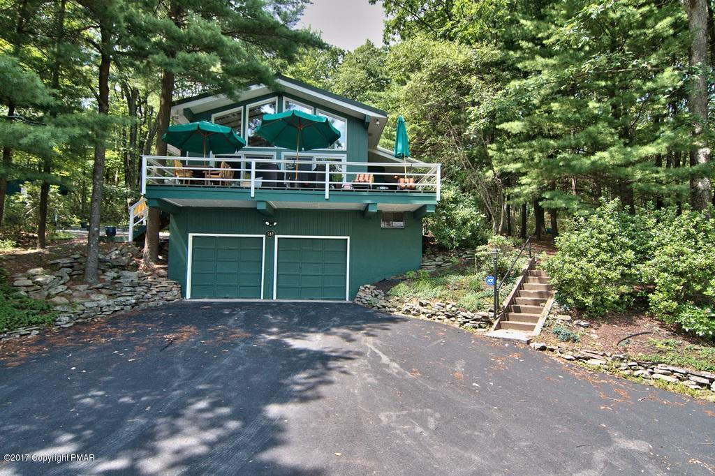 342 Summit Road Swiftwater, PA 18370 - Photo 1 of 53 a front view of a house with a garden and trees