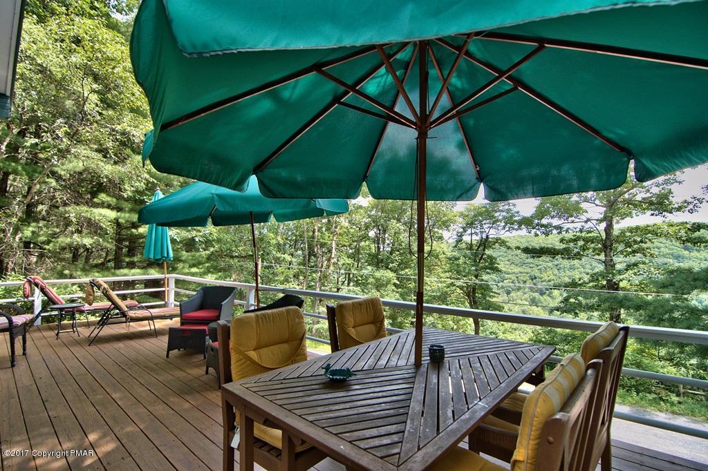 342 Summit Road Swiftwater, PA 18370 - Photo 11 of 53 a view of balcony with furniture and umbrella