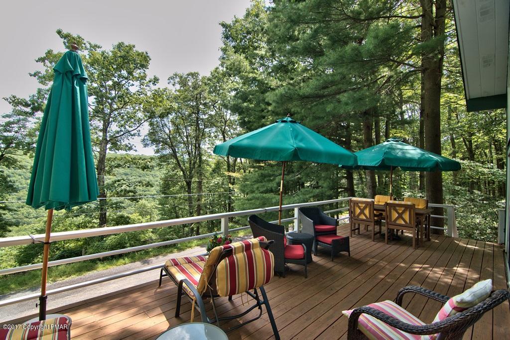 342 Summit Road Swiftwater, PA 18370 - Photo 12 of 53 an outdoor sitting area with furniture and umbrella