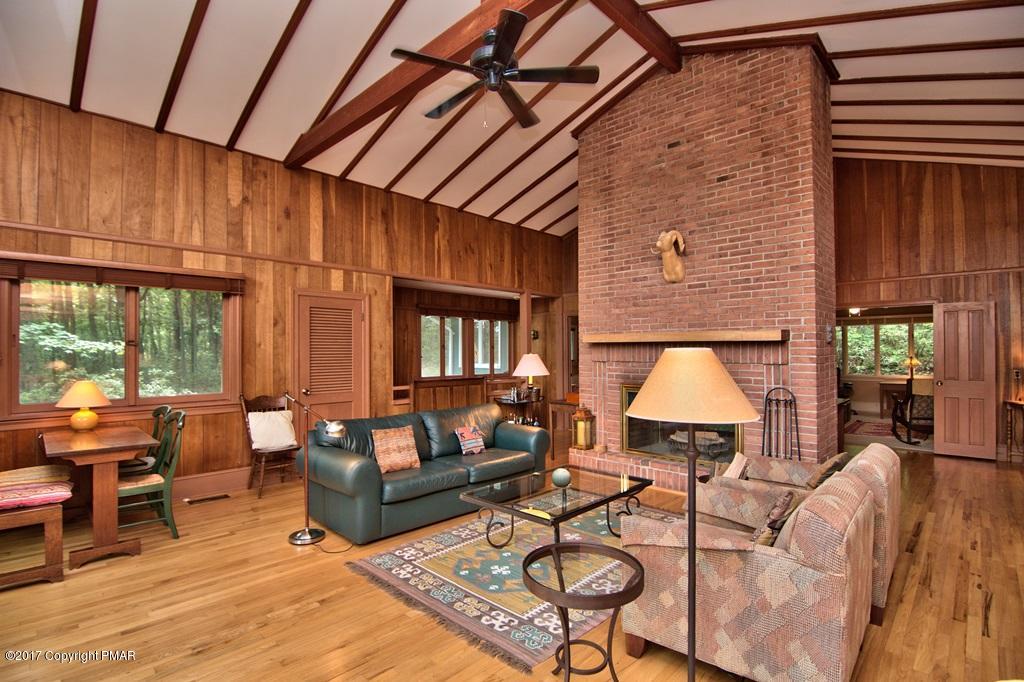 342 Summit Road Swiftwater, PA 18370 - Photo 17 of 53 a living room with furniture a lamp wooden floor and a table