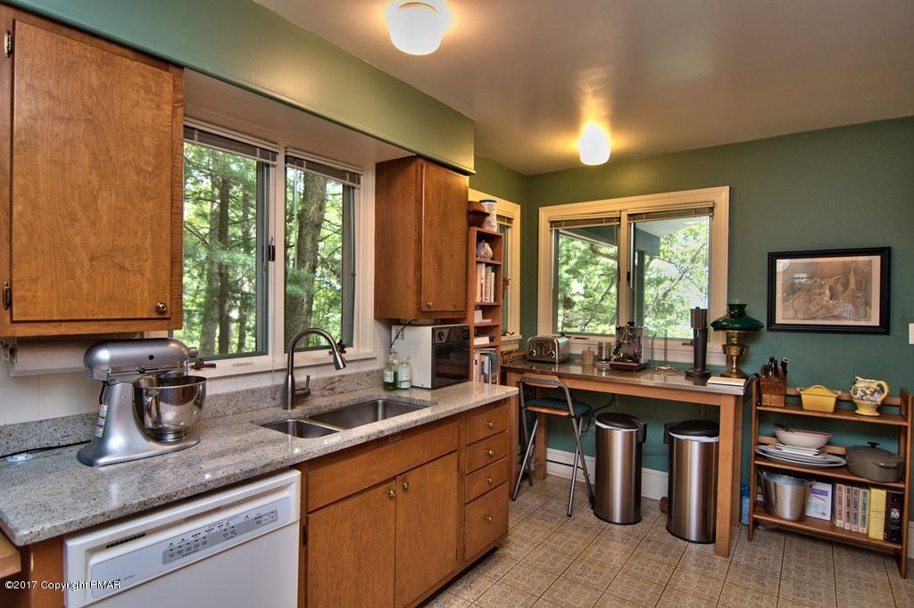342 Summit Road Swiftwater, PA 18370 - Photo 26 of 53 a kitchen with lots of counter top space and wooden floor