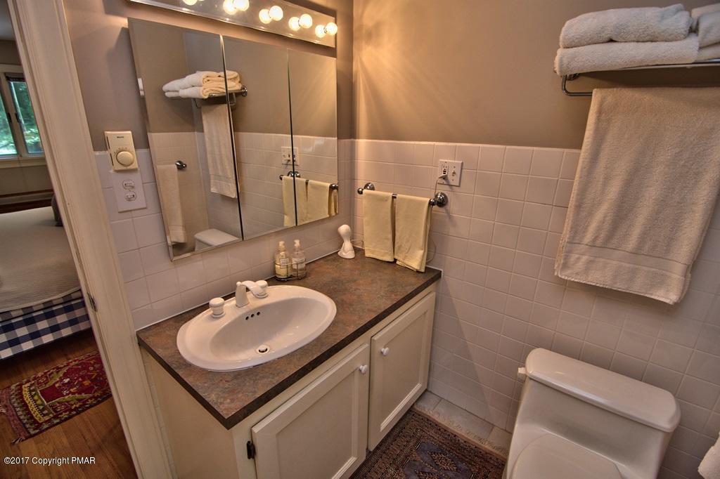342 Summit Road Swiftwater, PA 18370 - Photo 33 of 53 a bathroom with a sink toilet and mirror