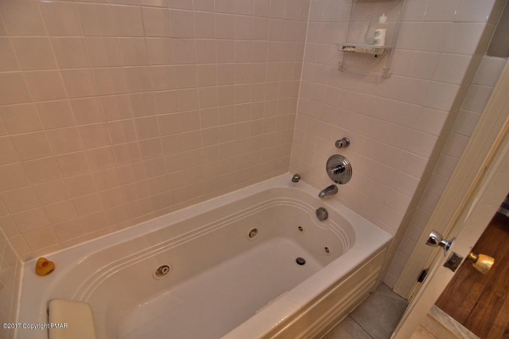 342 Summit Road Swiftwater, PA 18370 - Photo 34 of 53 a bathroom with a tub and a shower