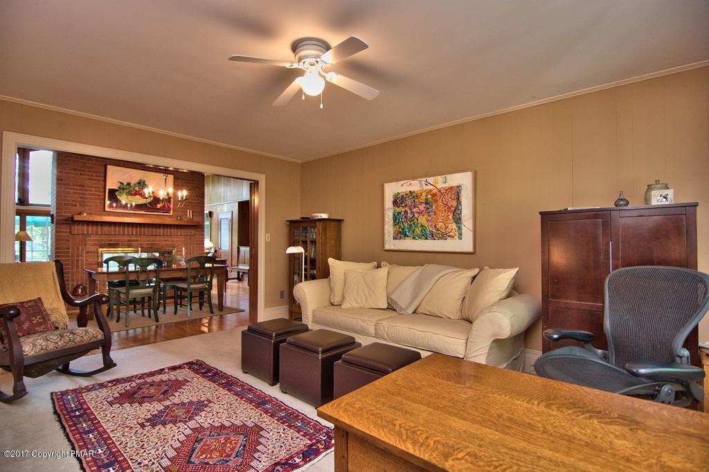 342 Summit Road Swiftwater, PA 18370 - Photo 35 of 53 a living room with furniture a rug and a chandelier