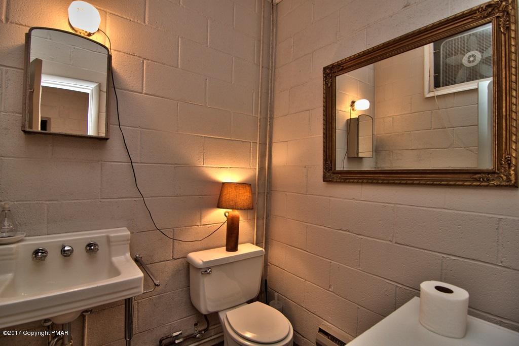 342 Summit Road Swiftwater, PA 18370 - Photo 47 of 53 a bathroom with a toilet sink and mirror
