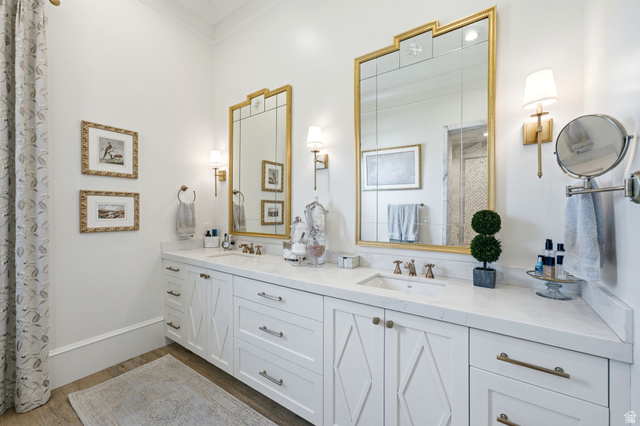 71 Farm Road Midway, UT 84049 - Photo 36 of 92 Double vanity featuring white cabinetry with brushed gold hardware, integrated sinks, and a stone countertop